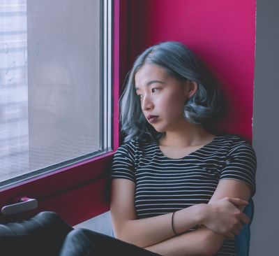 woman looking out a window